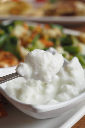 fresh yogurt in a bowl on tableの写真素材