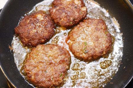 Enjoy these Deliciously Fried Meat Patties that are cooked perfectly in a skillet or panの写真素材