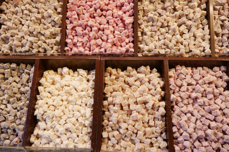 Assorted Colorful Confectionery Cubes Arranged Neatly Inside Beautiful Wooden Compartmentsの写真素材