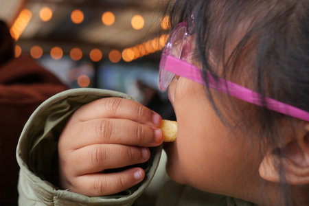 child eating french fries close upの写真素材