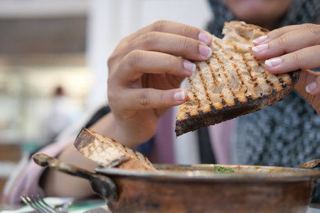 Enjoying Delicious Bread with Warm Soup at a Cozy Cafの写真素材
