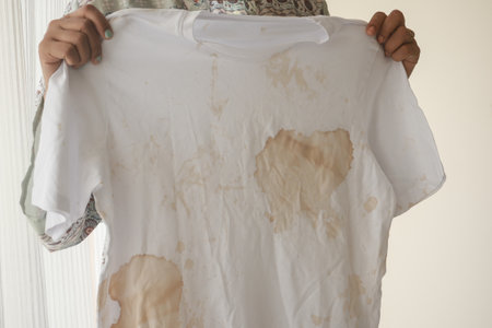 A stained white t-shirt that features noticeable marks on itの写真素材