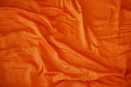 An Elegant Orange Silk Fabric Texture Background That is Ideal for Various Creative Usesの写真素材