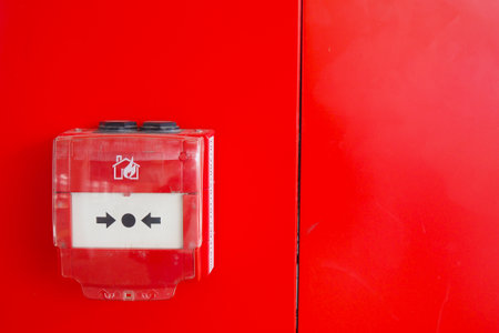Red fire alarm button on wall ,の写真素材