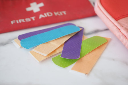 Colorful Bandaids and a wellorganized First Aid Kit on a stunning marble surface