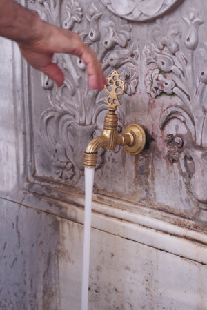 This is a beautiful antique water faucet featuring a delightful flow of refreshing waterの写真素材