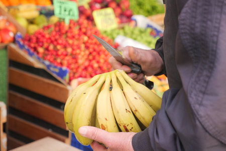 Enjoy Fresh Bananas Available at Your Local Market Surrounded by a Colorful Produce Backgroundの写真素材
