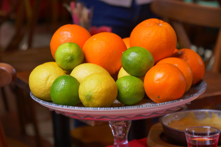 A Vibrant and Colorful Assortment of Fresh Citrus Fruits Presented on a Decorative Plateの写真素材