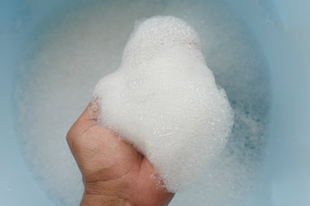 A small amount of soapy foam was collected in a bucket for household cleaning and hygieneの写真素材