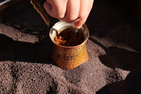 top view of making traditional turkish coffee on sandの写真素材