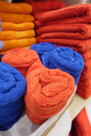 Bright Orange and Deep Blue Rolled Towels add flair and unique style to any spaceの写真素材