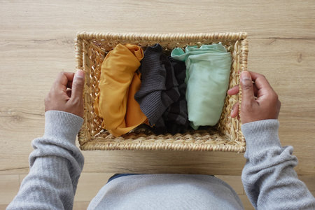 Colorful Rolled Clothing Neatly Arranged in a Beautiful Natural Basket for Organization