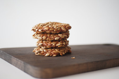 Indulgent and Delicious Healthy Oatmeal Cookies Beautifully Stacked on a Rustic Wooden Boardの写真素材