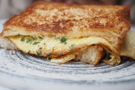 A savory Cloudy Cheese Omelette Sandwich on crispy toast, ideal for any meal or snack