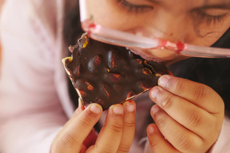 child eating dark chocolate close upの写真素材