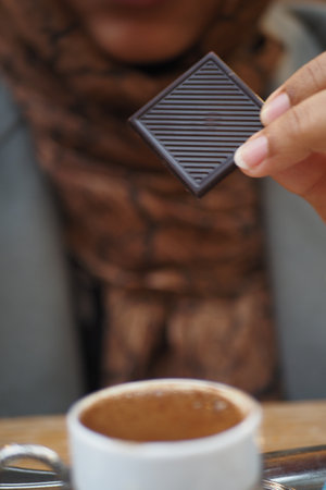Closeup of woman eating chocolate candyの写真素材