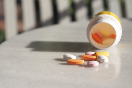 Pills are scattered and an open bottle is placed on the table, suggesting a recent use