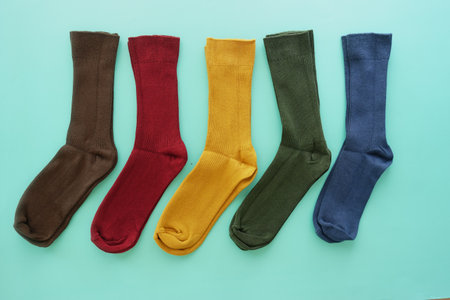 Explore our vibrant and colorful socks collection showcased beautifully on a mint backgroundの写真素材
