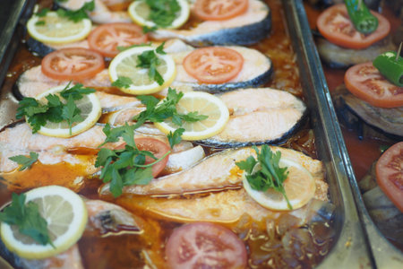 Enjoy a delicious baked fish with fresh herbs and vibrant vegetables for a delightful mealの写真素材