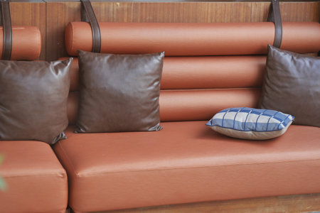 A modern leather sofa beautifully adorned with colorful decorative pillows for added comfort