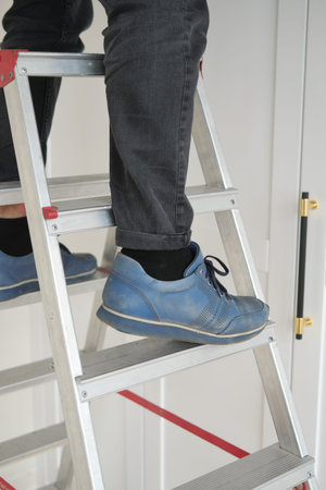 A person on a ladder in bright blue shoes shows skills like balance, climbing, and coordination