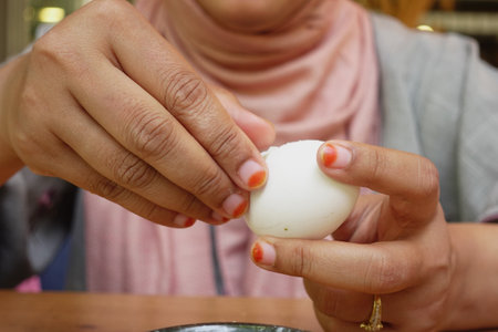 women hand perfectly Peeled Boiled Eggsの写真素材