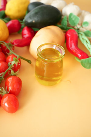 Vibrant fresh vegetables arranged beautifully with olive oil on a bright backgroundの写真素材