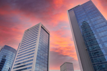 Captivating and stunning view of an Urban Skyline beautifully enhanced by Dramatic Sunset Cloudsの写真素材