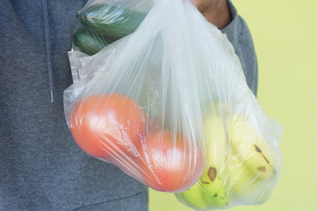 Hand Carrying Fresh Vegetables in Clear Plastic Bag, Healthy Eating and Zero Waste Concept