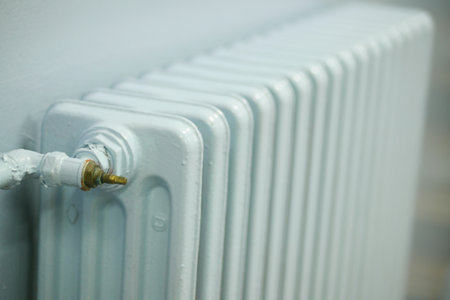blue radiator on grey white wall. apartment heating installation system,の写真素材