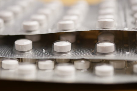 A detailed view of white pills neatly arranged in their blister packs