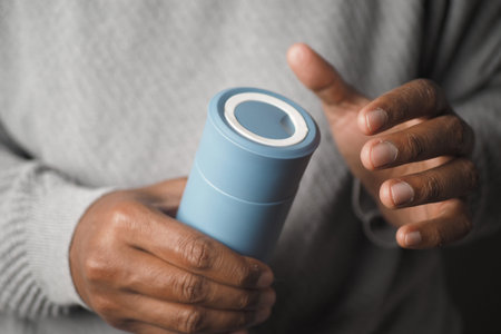 hand holding blue reusable steel stainless thermo water bottle