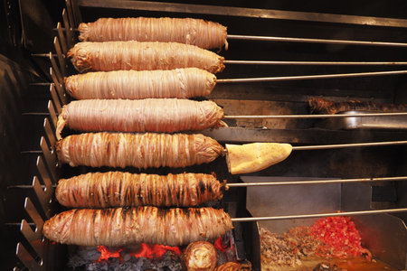 Traditional Skewered Meats Roasting Over Open Flames in a Turkish Kitchenの写真素材