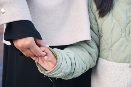 Tender Moment A Child Holding an Adults Hand, a beautiful symbol of love and connectionの写真素材