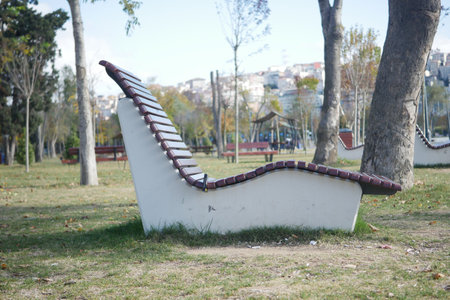 The Innovative Outdoor Bench Design Takes Center Stage in a Beautiful Green Park Settingの写真素材
