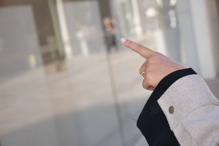The Gesture of Hand Pointing in a Bustling Urban Environment Todayの写真素材