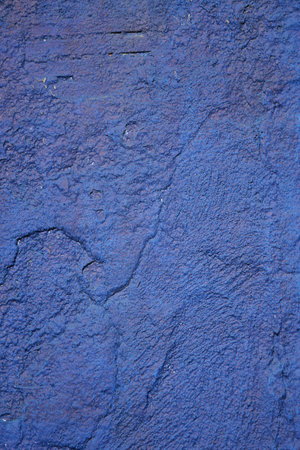 A vibrant blue textured wall background radiating energy and creativityの写真素材