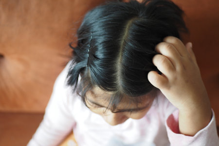 A Child Engaged in Thought While Sitting on a Couchの写真素材