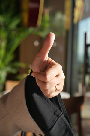 A Cheerful and Positive Thumbs Up Gesture in a Contemporary Modern Settingの写真素材