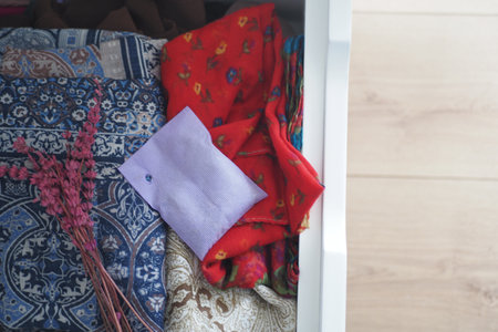 A Collection of Colorful Textiles and Accessories Neatly Stored in a Drawerの写真素材