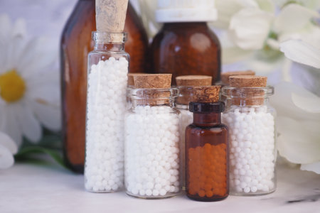 Homeopathic pills containers on a tableの写真素材