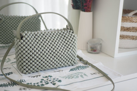 A Beautiful and Stylish Green Handbag Featuring a Unique Beaded Designの写真素材