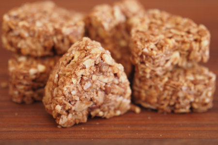 Nutty Granola Snack Bites Arranged Artfully on a Wooden Surfaceの写真素材