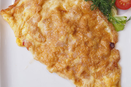 A Delicious Golden Omelette Beautifully Served on a Plate, Perfectly Ready to Be Enjoyedの写真素材