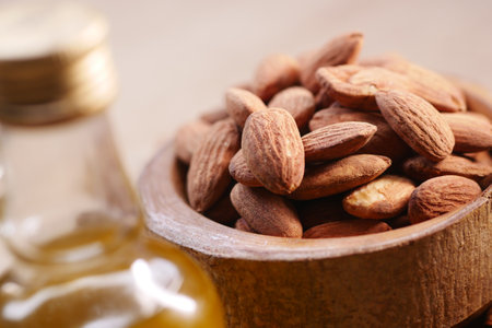 almond oils and fresh nuts on tableの写真素材