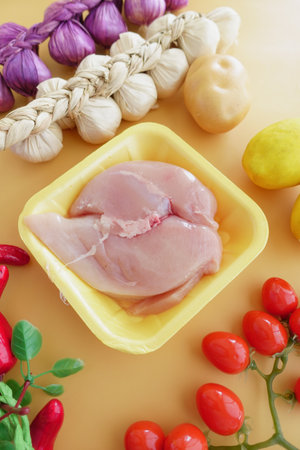 Delicious Fresh Chicken Prepared with a Variety of Colorful Vegetables and Herbsの写真素材