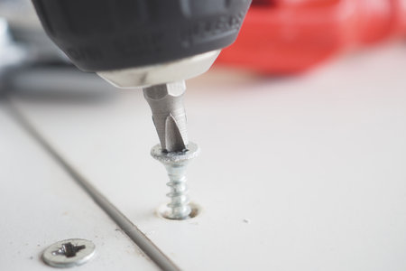 Precision Screwdriving with Electric Tool in Workshopの写真素材