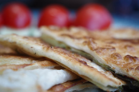 A Tasty and Delicious Flatbread Topped with Fresh Tomatoes Served on a Plateの写真素材