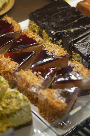 A Delicious Assortment of Colorful Cakes and Tempting Pastries Await Youの写真素材