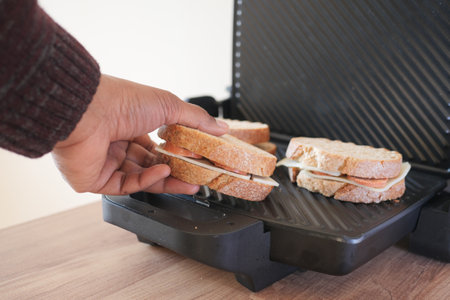 Enjoy grilling a delicious burger with fresh, quality ingredients for the best flavorsの写真素材